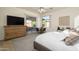 Bright bedroom with king-size bed and private access at 17824 W Addie Ln, Surprise, AZ 85374