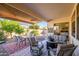 Covered patio with seating area, fire pit, and dining table at 17824 W Addie Ln, Surprise, AZ 85374