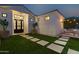 Landscaped front yard with artificial turf and stone pathway at 18335 W Orangewood Ave, Waddell, AZ 85355