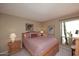 Bedroom with wood bed frame and large window at 18658 E Mazatzal Cir, Rio Verde, AZ 85263