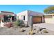 Front view of a charming single story home with a spacious driveway and drought-tolerant landscaping at 18658 E Mazatzal Cir, Rio Verde, AZ 85263