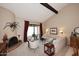 Spacious living room with a fireplace, high ceilings, and access to a patio at 18658 E Mazatzal Cir, Rio Verde, AZ 85263