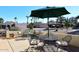 Relaxing patio area with outdoor furniture, umbrella, and view of the neighborhood at 18658 E Mazatzal Cir, Rio Verde, AZ 85263
