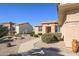 Tan house with tile roof, walkway, and desert landscaping at 20516 N Vermillion Cliffs Dr, Surprise, AZ 85387