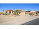House exterior with a two-car garage and desert landscaping at 20516 N Vermillion Cliffs Dr, Surprise, AZ 85387