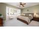 Large main bedroom with window seating and ceiling fan at 20516 N Vermillion Cliffs Dr, Surprise, AZ 85387