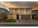 Two-story house with a gray-green garage door and landscaped lawn at 22124 N 34Th St, Phoenix, AZ 85050