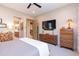 Bedroom with a king-size bed, dresser, and views into the kitchen and bathroom at 40 Almarte Cir, Carefree, AZ 85377