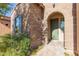 Inviting front entry with brick facade and green door at 40 Almarte Cir, Carefree, AZ 85377