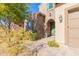 Home exterior with brick, green door and landscaping at 40 Almarte Cir, Carefree, AZ 85377