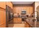 Updated kitchen with stainless steel appliances and wood cabinets at 40 Almarte Cir, Carefree, AZ 85377