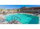 Sparkling community pool with lounge chairs and patio umbrellas at 40 Almarte Cir, Carefree, AZ 85377