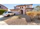 Two-story house with a two-car garage and desert landscaping at 4826 S 26Th Ln, Phoenix, AZ 85041