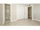 Bedroom with tile floors, double door closet and bathroom access at 4913 W Palm Ln, Phoenix, AZ 85035