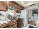 Kitchen features wood cabinets, microwave, and refrigerator at 5308 N 2Nd Ave, Phoenix, AZ 85013