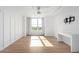 Bedroom with hardwood floors, large window and built in entertainment center at 535 W Thomas Rd # 508, Phoenix, AZ 85013