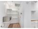 Bright white pantry with shelving and microwave at 535 W Thomas Rd # 508, Phoenix, AZ 85013