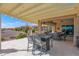 Covered patio with outdoor dining furniture and a beautiful view at 5841 W Bushwood Ct, Florence, AZ 85132