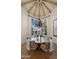 Elegant dining room features a round table, chandelier, and hardwood floors at 7500 E Mccormick Pkwy # 11, Scottsdale, AZ 85258