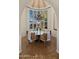Charming dining room with a round table, chandelier, and view to garden at 7500 E Mccormick Pkwy # 11, Scottsdale, AZ 85258