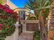 Ornate entry gate with terracotta tile walkway and bougainvillea at 7500 E Mccormick Pkwy # 11, Scottsdale, AZ 85258