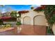 Two-car garage with terracotta driveway and bougainvillea at 7500 E Mccormick Pkwy # 11, Scottsdale, AZ 85258