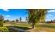 Landscaped walkway alongside a vibrant green golf course at 7500 E Mccormick Pkwy # 11, Scottsdale, AZ 85258