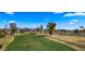 Aerial view of a lush green golf course with mountains in the background at 7500 E Mccormick Pkwy # 11, Scottsdale, AZ 85258