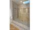 Walk-in shower with glass enclosure and tiled walls at 7500 E Mccormick Pkwy # 11, Scottsdale, AZ 85258