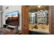 Wet bar with sink, glass shelving, and decorative wood accents at 7500 E Mccormick Pkwy # 11, Scottsdale, AZ 85258