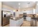 Modern kitchen with granite island, stainless steel appliances, and white cabinets at 8962 W Adam Ave, Peoria, AZ 85382