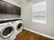 Laundry room with washer, dryer, and cabinets at 10510 E Neville Ave, Mesa, AZ 85209