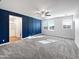 Spacious main bedroom with blue accent wall and plush carpeting at 10510 E Neville Ave, Mesa, AZ 85209