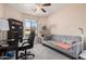 Bright bedroom with a comfy couch, workspace, and built-in shelving at 10960 E Monte Ave # 125, Mesa, AZ 85209