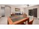 Bright dining area with tile flooring and a wooden table at 10960 E Monte Ave # 125, Mesa, AZ 85209