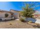 Single-story home with two-car garage and desert landscaping at 10960 E Monte Ave # 125, Mesa, AZ 85209