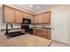 Modern kitchen with wood cabinets and black appliances at 10960 E Monte Ave # 125, Mesa, AZ 85209
