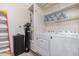 Laundry room with washer, dryer, water softener, and storage at 10960 E Monte Ave # 125, Mesa, AZ 85209