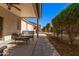 Long covered patio, wicker furniture, and view of backyard at 10960 E Monte Ave # 125, Mesa, AZ 85209
