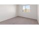 Simple bedroom with a window and carpet flooring at 1203 E Muriel Dr, Phoenix, AZ 85022