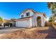 Two-story house with a white exterior, attached garage, and landscaping at 1203 E Muriel Dr, Phoenix, AZ 85022