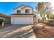 Two-story house with a white exterior, attached garage, and landscaping at 1203 E Muriel Dr, Phoenix, AZ 85022