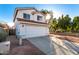 Two-story house with a white exterior, attached garage, and landscaping at 1203 E Muriel Dr, Phoenix, AZ 85022