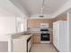 Kitchen with light wood cabinets and white appliances at 1203 E Muriel Dr, Phoenix, AZ 85022