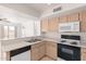 Well-equipped kitchen with modern appliances and wood cabinets at 1203 E Muriel Dr, Phoenix, AZ 85022