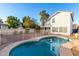 Relaxing kidney-shaped pool, surrounded by a fence at 1203 E Muriel Dr, Phoenix, AZ 85022