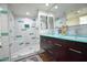 Double vanity bathroom with a teal countertop and tiled shower at 1326 N Central Ave # 416, Phoenix, AZ 85004