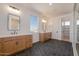 A spacious bathroom featuring dual sinks, hexagon floor tiles and vanity lighting at 1350 E Prescott St, Gilbert, AZ 85298