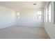 Bedroom with neutral carpet, white walls, and multiple windows at 1350 E Prescott St, Gilbert, AZ 85298