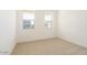 A bright bedroom with carpet floors and dual windows allowing for natural light at 1350 E Prescott St, Gilbert, AZ 85298